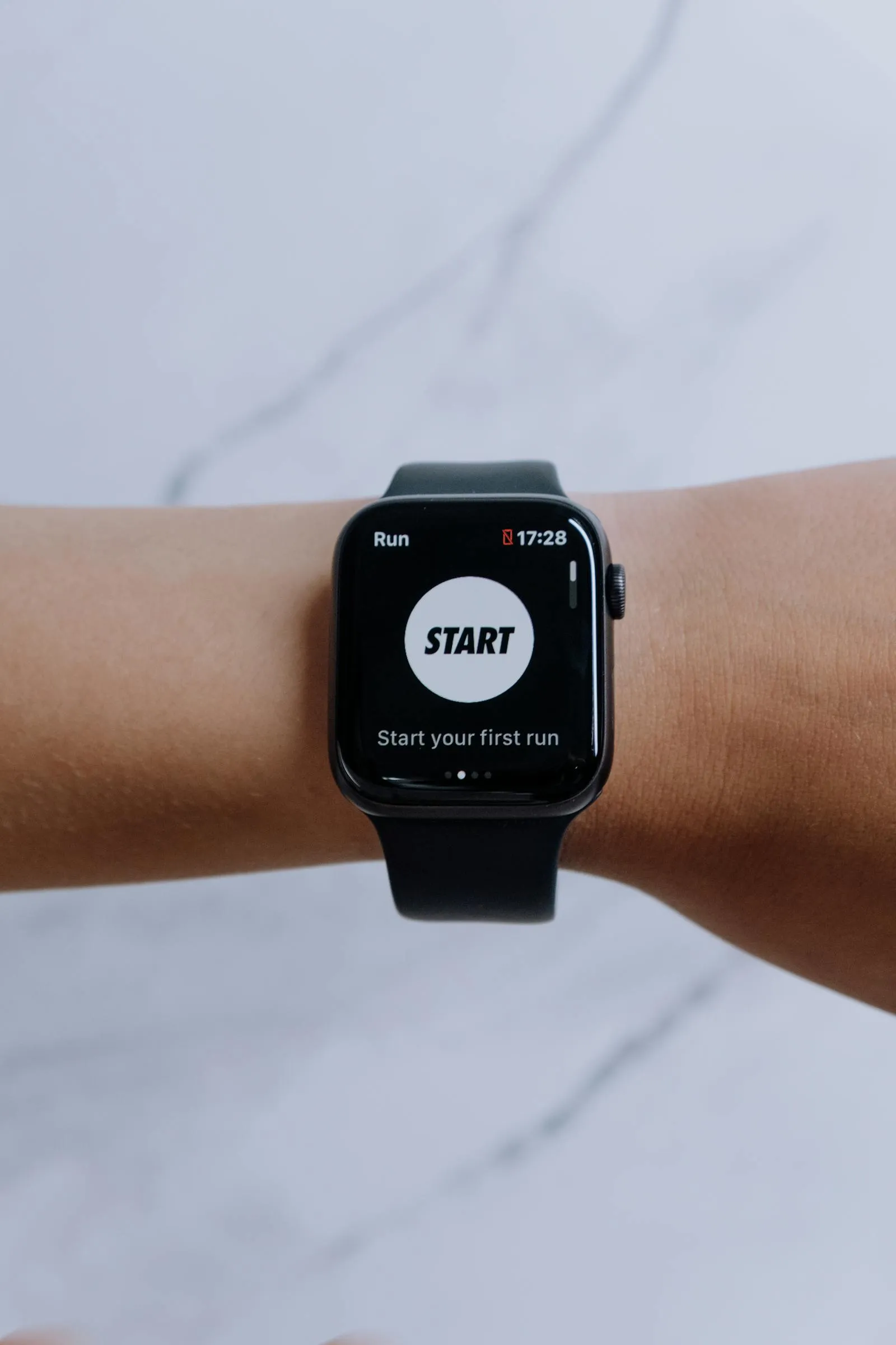 A smartwatch showing a running app's pace, distance, and calorie dashboard